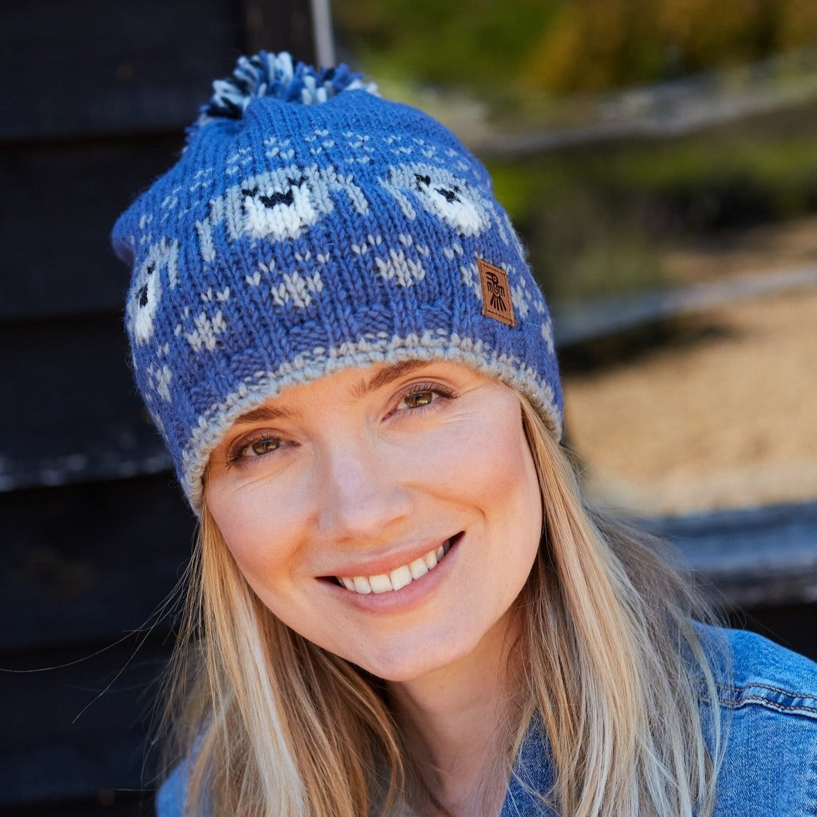 Blue bobble beanie with dog design all around with internal fleece lining