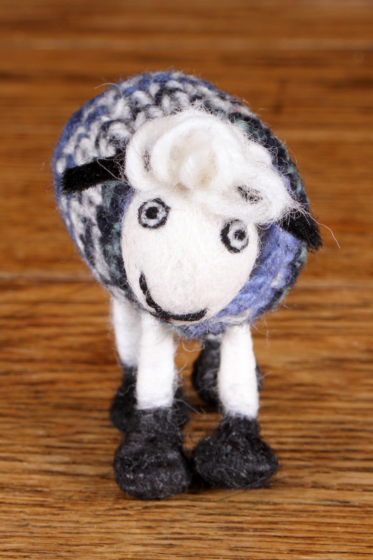 Cute felted sheep called Trevor wearing a blue tank top