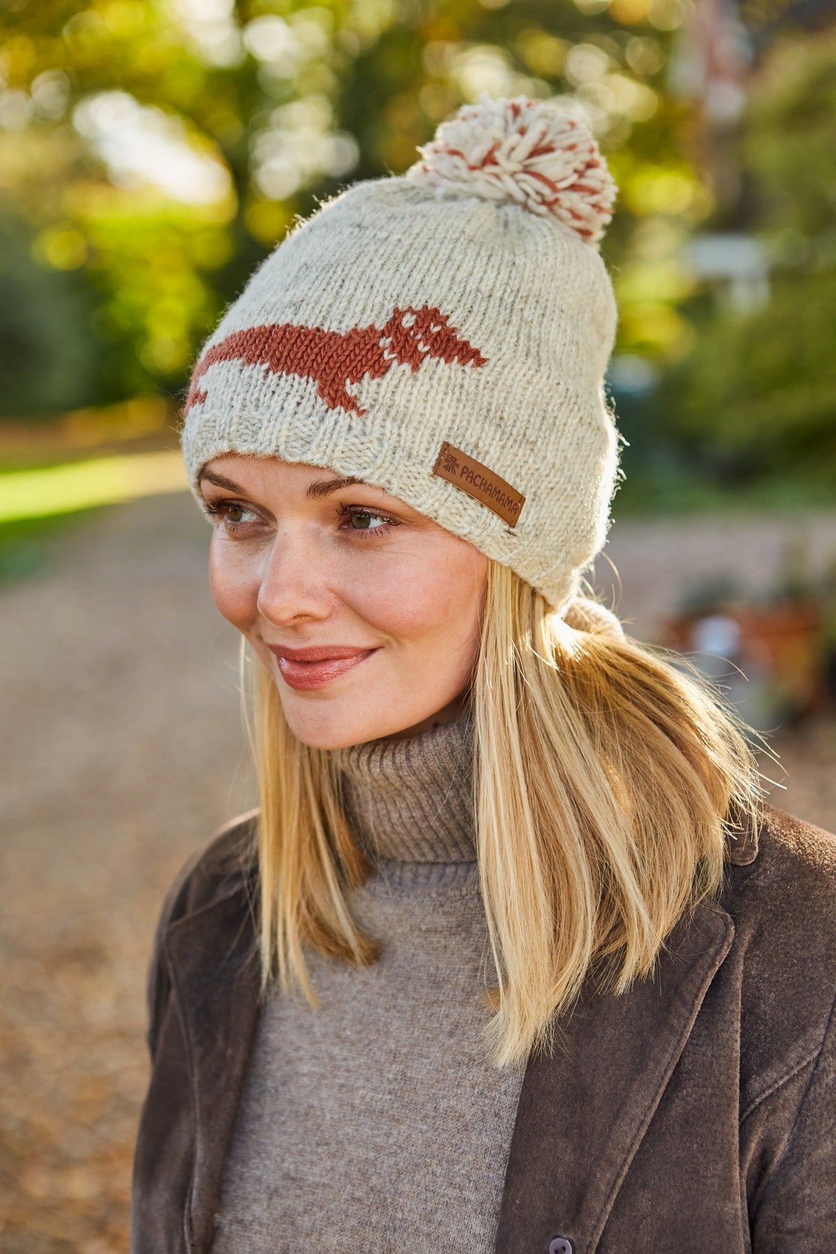 Lady wearing bobble beanie and smiling