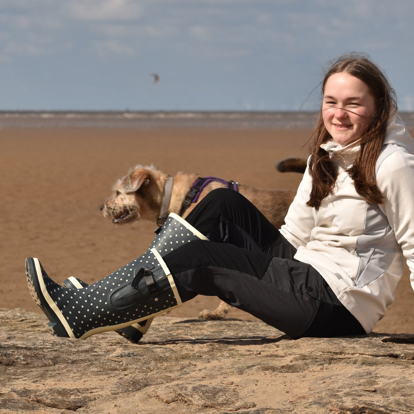 child wearing wellies with dog