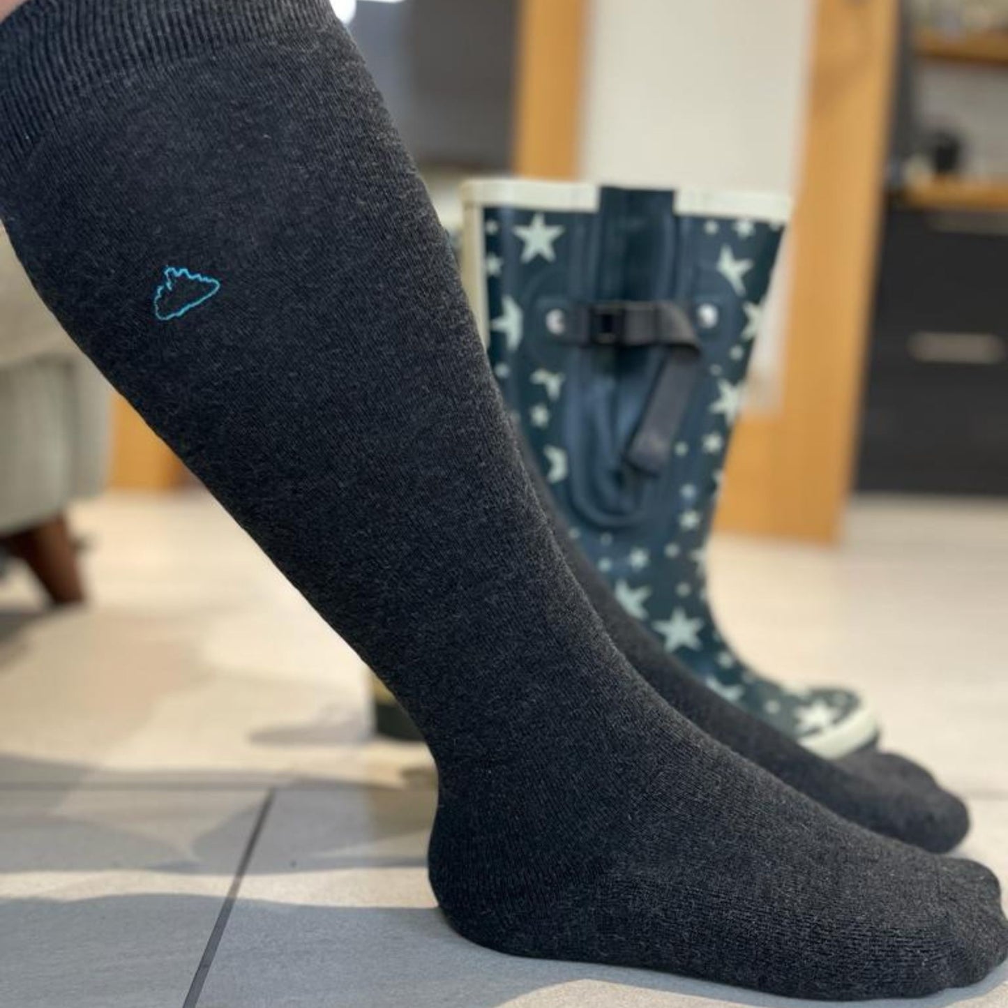 Man wearing grey wide calf socks suitable for wearing in wellies