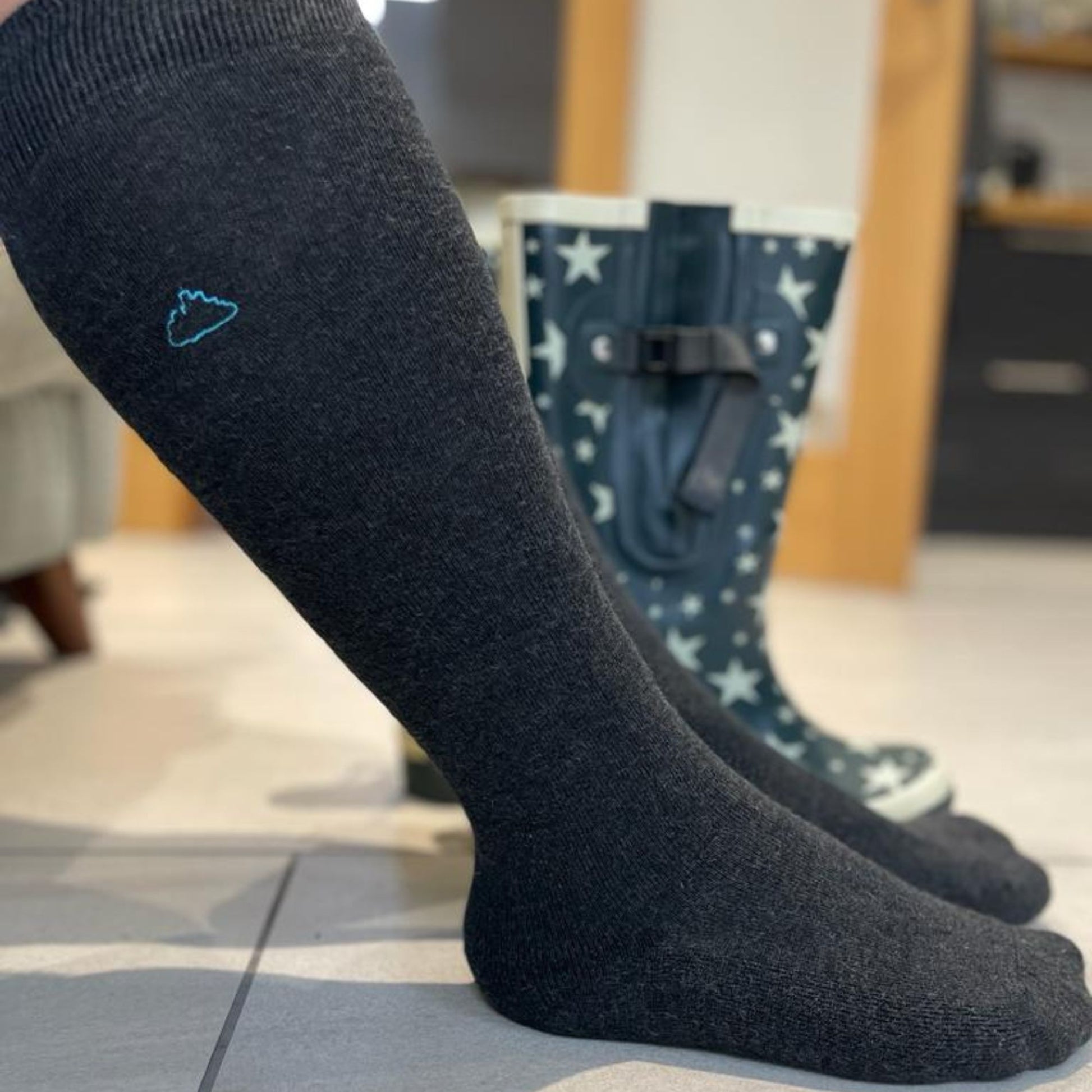 Man wearing grey wide calf socks suitable for wearing in wellies